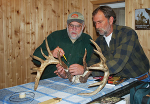boucher with buck The rack is examined.
