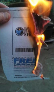 A would-be patron to the Eastern Sports and Outdoor Show burns his ticket out of disgust at the show's promoter for not allowing exhibitors to display modern sporting rifles (Facebook photo)
