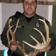Brian Sheetz, a wildlife conservation officer with the Pennsylvania Game Commission, holds the antlers of a deer illegally killed earlier this year.