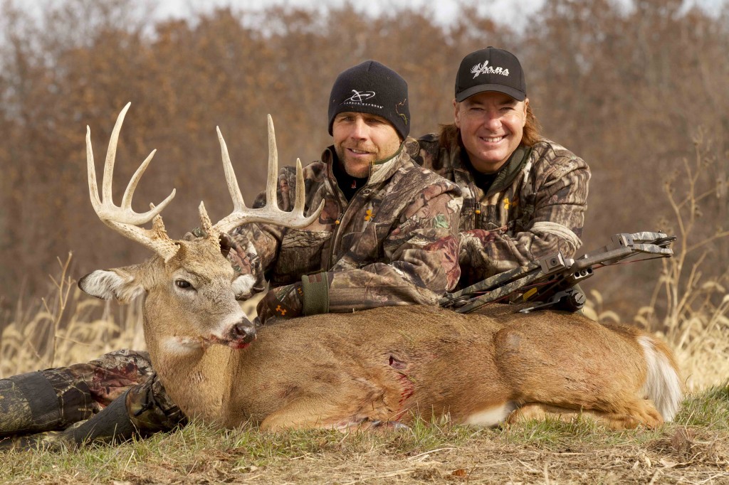 Shawn Michaels, left, with his MacMillan River Adventures co-host Keith Mark and a buck Michaels killed while filming a hunt.