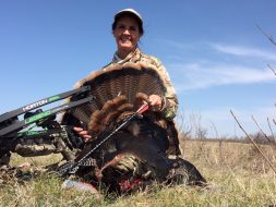 Crossbows aren't just for the autumn seasons, either! Kim Cahalan smiles behind a beautiful spring gobbler taken with a TenPoint crossbow in South Dakota last spring.