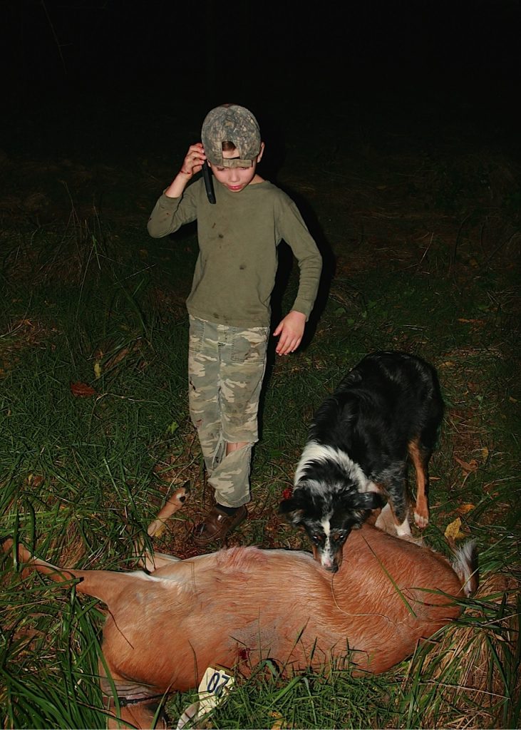 Paul Thoburn, age 7, makes a call to spread the news after his first bowhunt, which was a success.