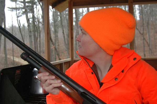 Tracy Schmidt scans the woods for deer.